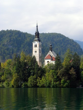 The picturesque Church of the Assumption sits in the middle of an alpine lake in the fairytale town of Bled, Slovenia