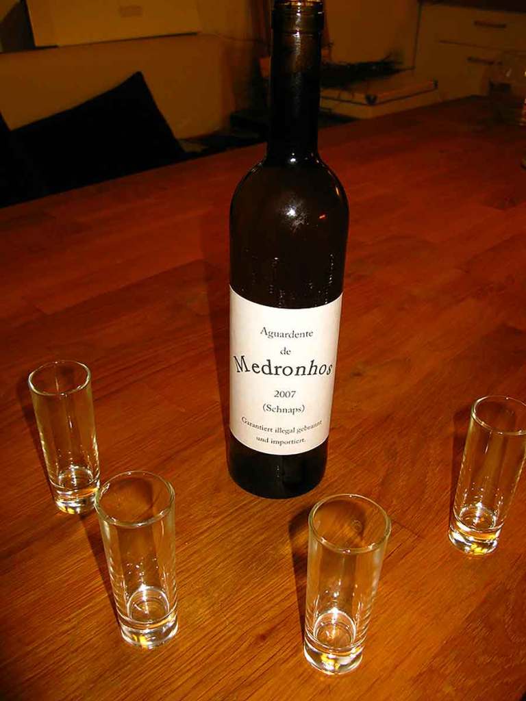 Aguardente bottle and shot glasses