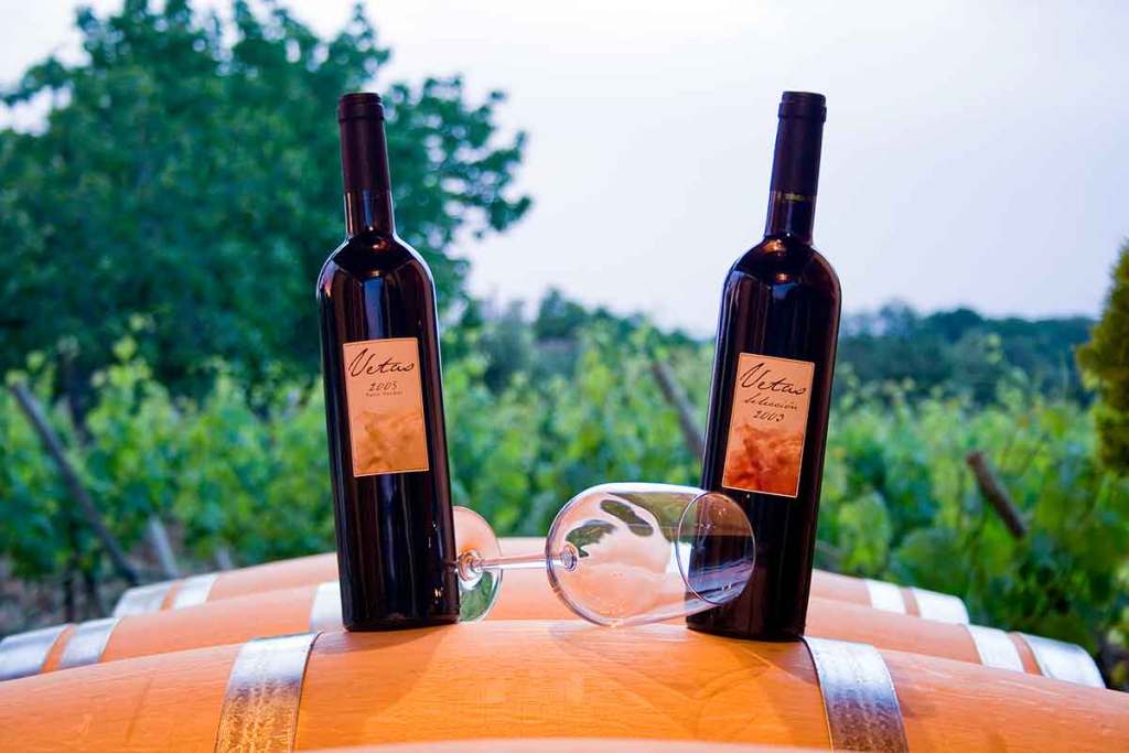 Malaga wine bottles on top of barrels for "Interesting Liquors from Around the World"