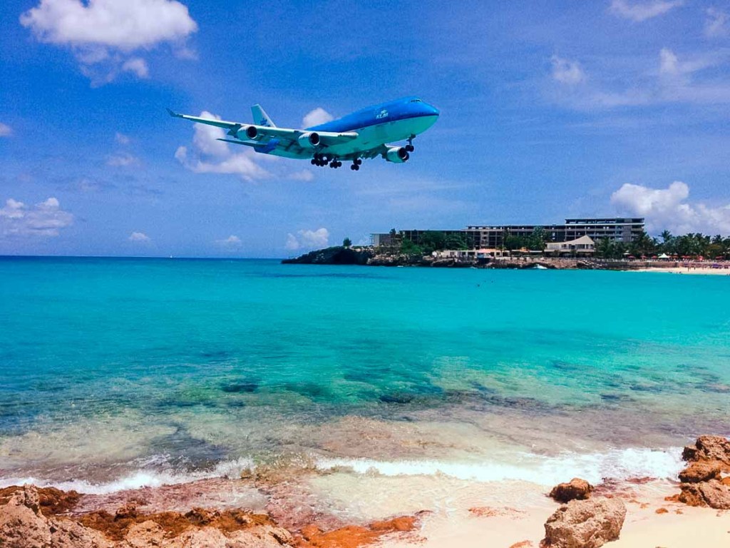 Plane landing over Sint Maarten, one of the lesser visited Caribbean beach vacation destinations
