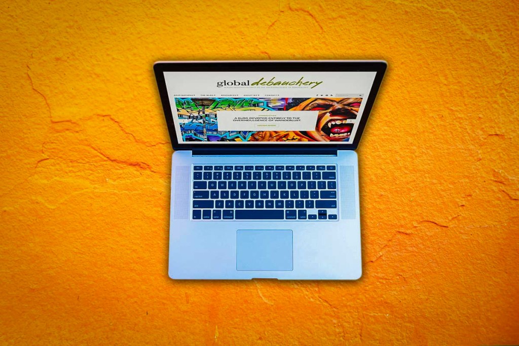 A laptop sitting on brightly painted concrete