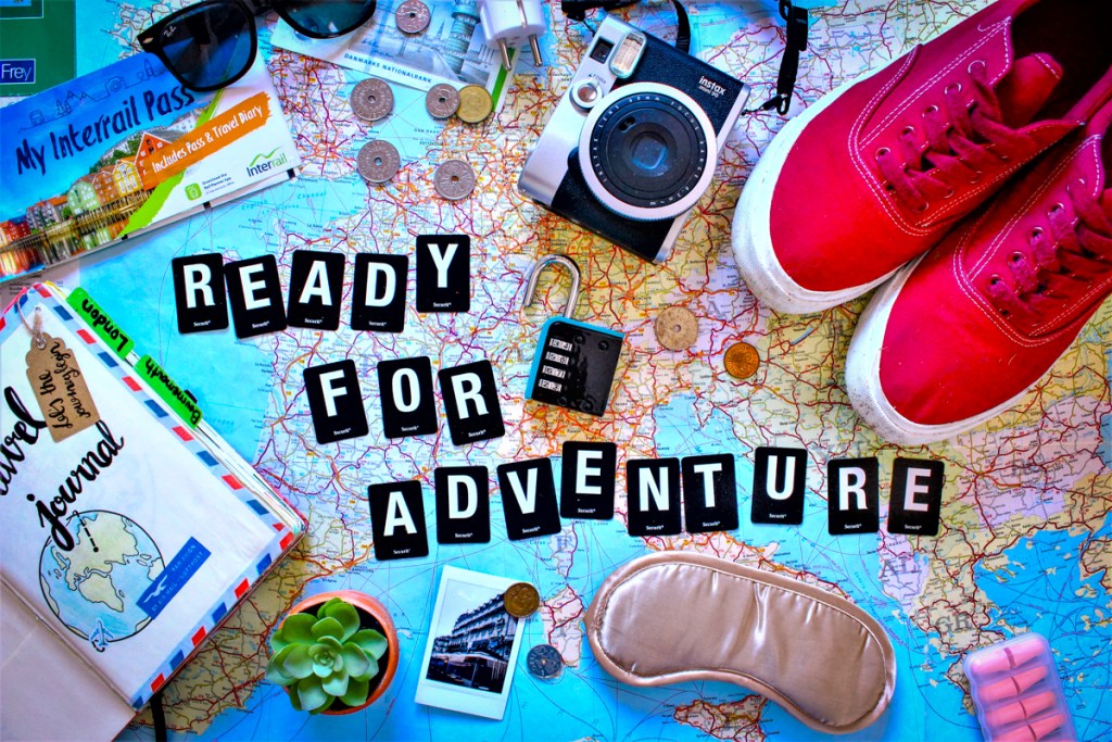 Travel supplies spread out across a world map