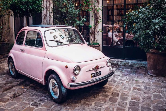 Super cute pink mini car, perfect for driving in France.