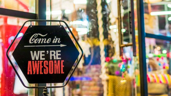 Shop sign with "Come In, We're Awesome" written on it