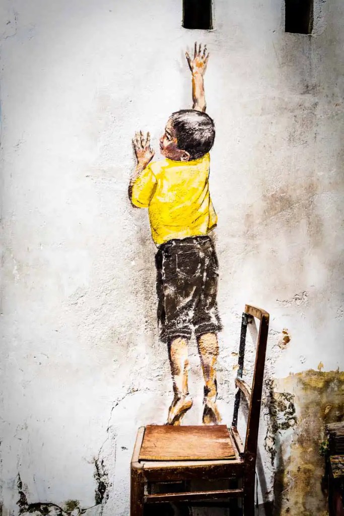 Penang street art "Boy Reaching Up"