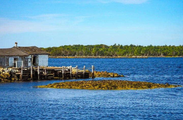 Fishing hut on the water in Port Medway on 7-day Lighthouse Route Nova Scotia itinerary
